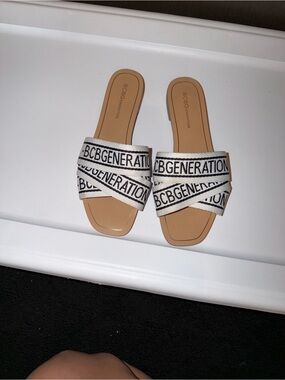 BCBGeneration White and Black Logo Crisscross Slide Sandals
